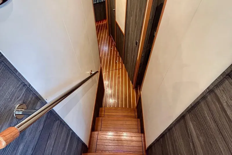 Redeye Yacht Photos Pics Staircase inside 2012 Tiara Yachts 48 CNV, featuring wooden steps and sleek handrail.