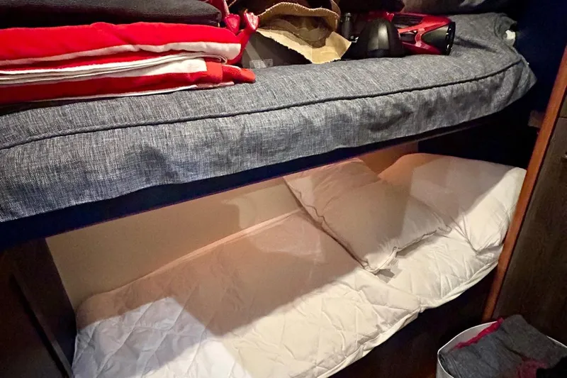 Redeye Yacht Photos Pics Bunk beds in 2012 Tiara Yachts 48 CNV cabin with cozy bedding and storage.