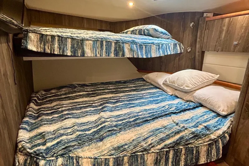 Redeye Yacht Photos Pics Bunk beds with blue striped bedding in 2012 Tiara Yachts 48 CNV cabin.