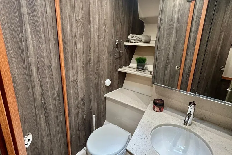 Redeye Yacht Photos Pics Luxurious bathroom in 2012 Tiara Yachts 48 CNV with wood paneling and modern fixtures.