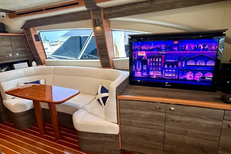 Redeye Yacht Photos Pics Luxurious 2012 Tiara Yachts 48 CNV interior with plush seating and large TV.