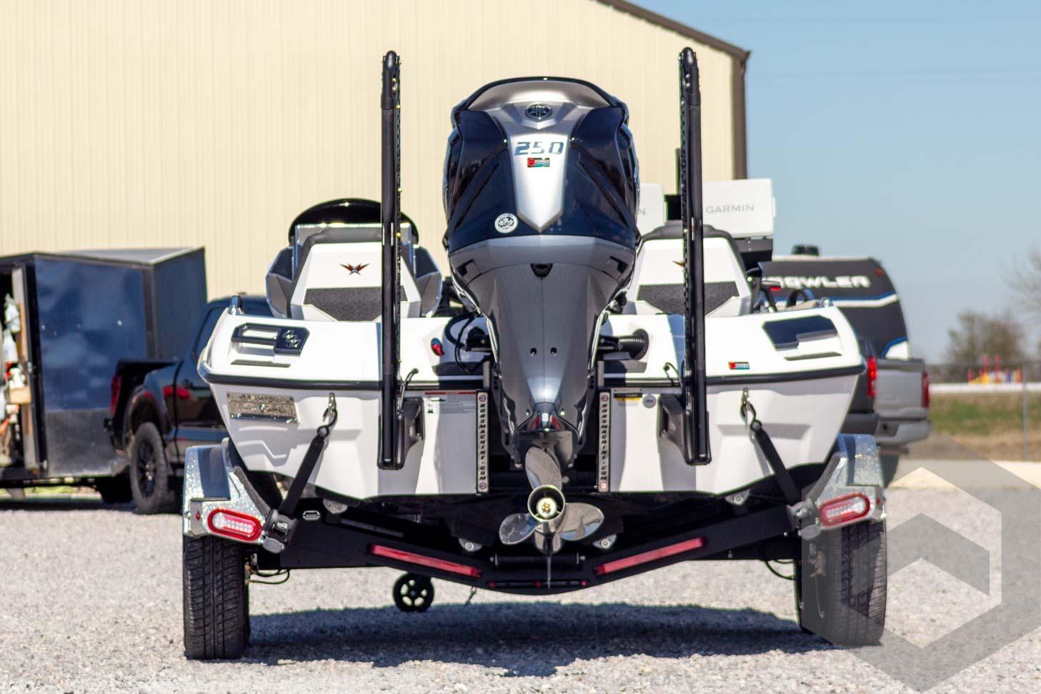 2026 Vexus VXs20 boat with powerful outboard motor, parked on gravel.