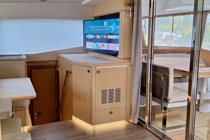 Emmanuel Yacht Photos Pics Luxurious interior of 2023 Privilege Signature 510 yacht with modern TV and elegant furnishings.