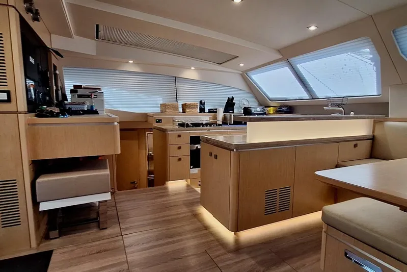 Emmanuel Yacht Photos Pics Luxurious interior of 2023 Privilege Signature 510 yacht with modern kitchen and seating area.