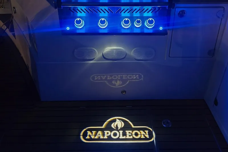 Emmanuel Yacht Photos Pics Blue-lit control panel on 2023 Privilege Signature 510 yacht, with "Napoleon" logo projection.