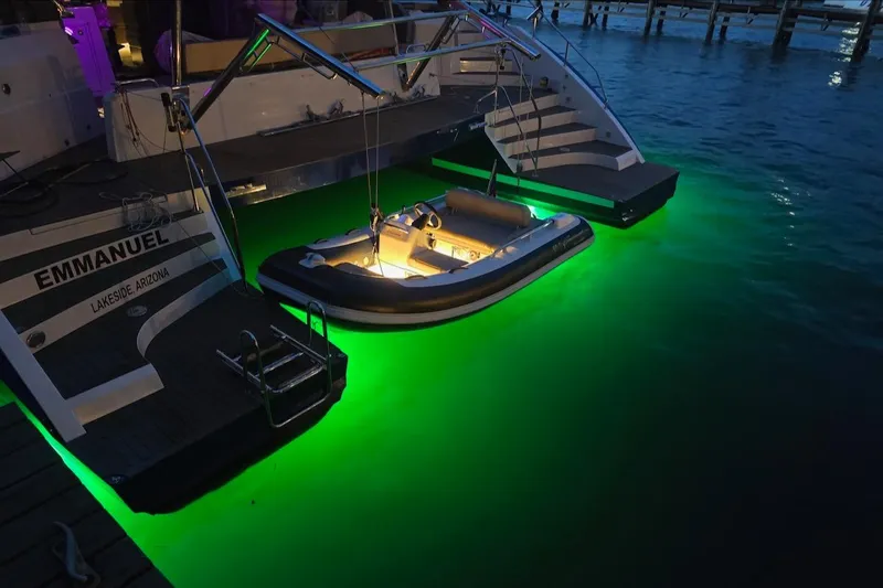 Emmanuel Yacht Photos Pics Luxury yacht Privilege Signature 510 with glowing green underwater lights at night.