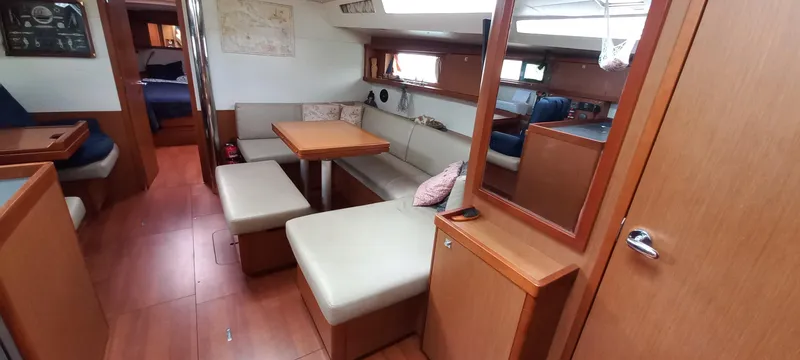 Lady Mys Yacht Photos Pics Interior of 2013 Beneteau Oceanis 48 yacht with wooden furnishings and seating area.