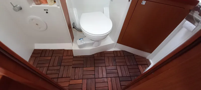 Lady Mys Yacht Photos Pics Bathroom interior of 2013 Beneteau Oceanis 48 yacht with wooden floor tiles.
