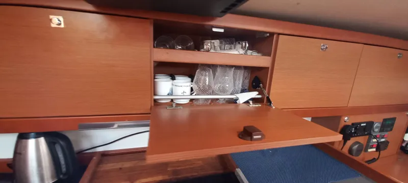 Lady Mys Yacht Photos Pics Interior of 2013 Beneteau Oceanis 48 yacht with wooden cabinets and kitchenware.