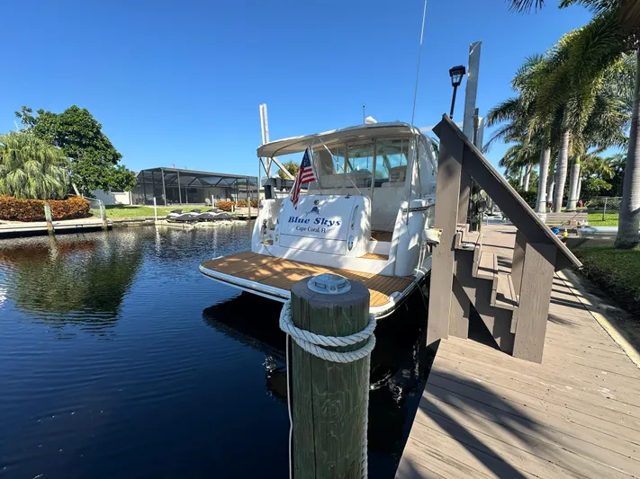  Yacht Photos Pics 2005 Tiara Yachts 3600 Sovran docked by palm trees and clear blue sky.