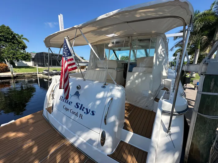  Yacht Photos Pics 2005 Tiara Yachts 3600 Sovran docked, featuring "Blue Skys" and American flag, Cape Coral, FL.