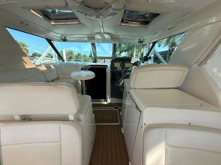  Yacht Photos Pics 2005 Tiara Yachts 3600 Sovran interior with white seating and wooden flooring.