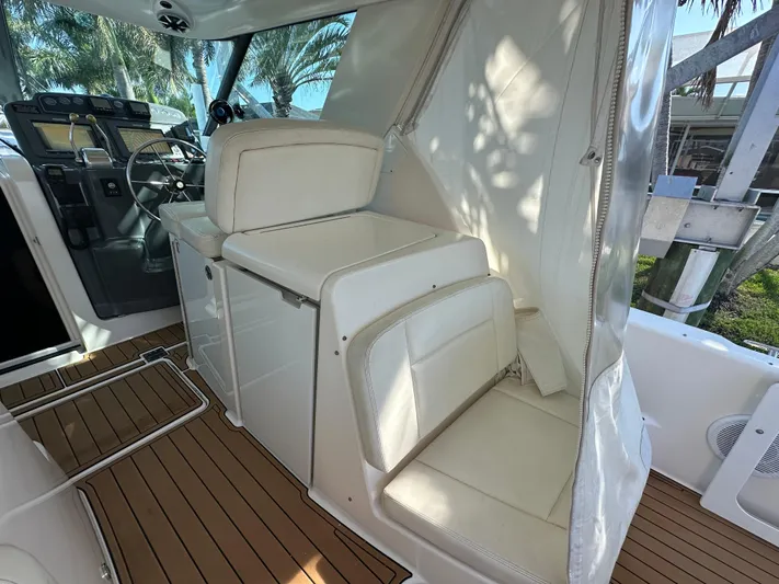  Yacht Photos Pics 2005 Tiara Yachts 3600 Sovran interior with white seating and wooden flooring.