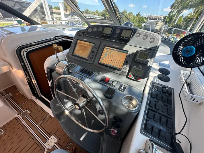  Yacht Photos Pics Control panel of 2005 Tiara Yachts 3600 Sovran with navigation screens and steering wheel.