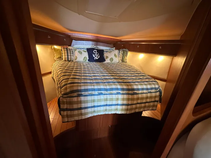  Yacht Photos Pics Cozy cabin interior of 2005 Tiara Yachts 3600 Sovran with plaid bedding and ambient lighting.