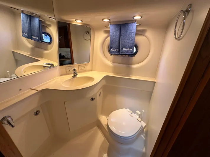  Yacht Photos Pics Luxurious bathroom in 2005 Tiara Yachts 3600 Sovran with modern fixtures and porthole window.