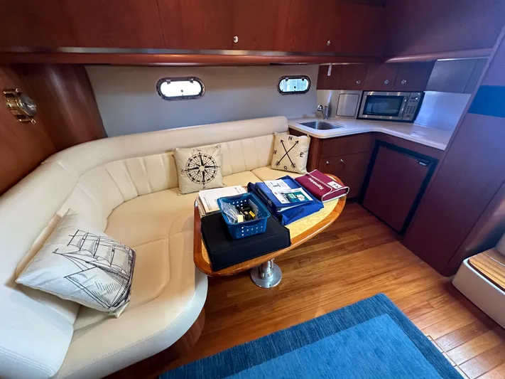  Yacht Photos Pics Luxurious 2005 Tiara Yachts 3600 Sovran interior with cozy seating and modern kitchenette.