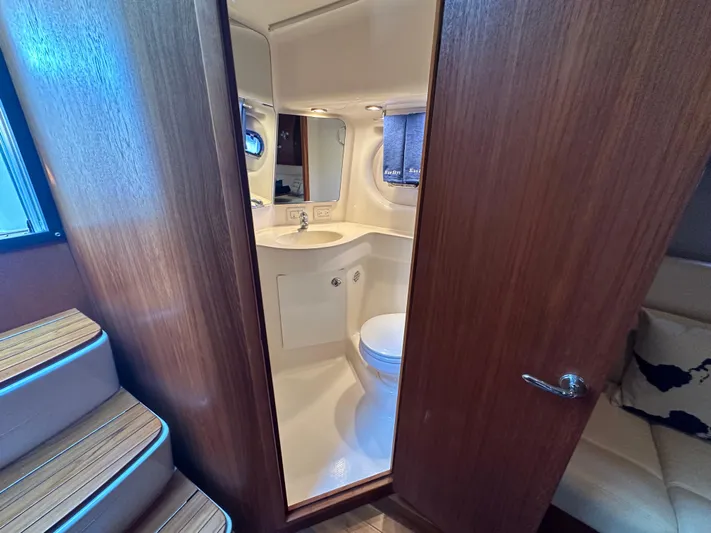  Yacht Photos Pics 2005 Tiara Yachts 3600 Sovran bathroom interior with modern fixtures and wooden accents.