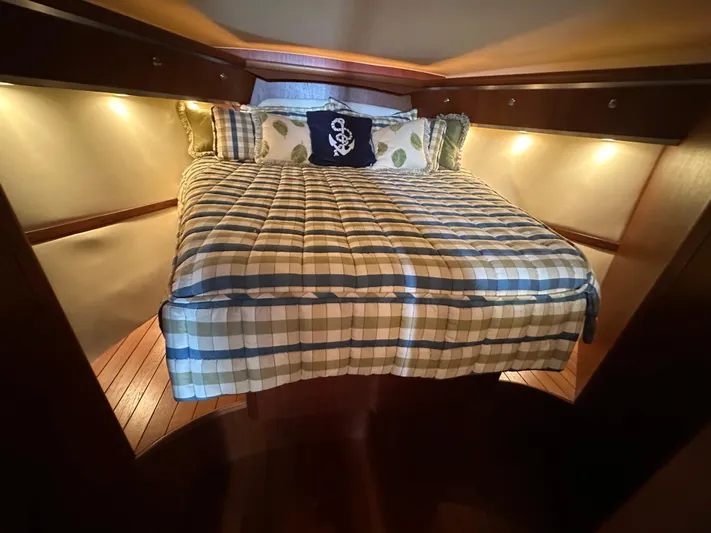  Yacht Photos Pics Cozy cabin interior of 2005 Tiara Yachts 3600 Sovran with plaid bedding and ambient lighting.