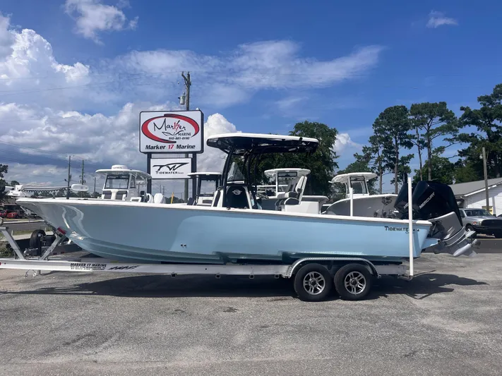  Yacht Photos Pics 2023 Tidewater 2700 Carolina Bay boat on trailer at marina under blue sky.
