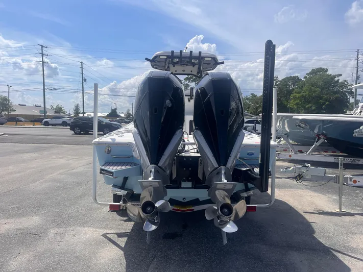  Yacht Photos Pics 2023 Tidewater 2700 Carolina Bay boat with dual outboard motors, parked outdoors.