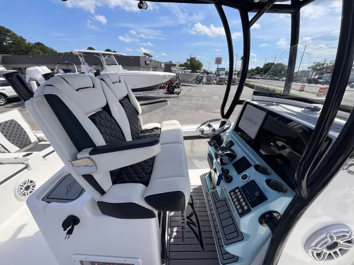  Yacht Photos Pics 2023 Tidewater 2700 Carolina Bay boat interior with dual seats and control panel.