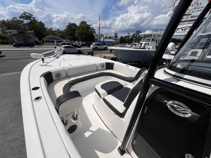  Yacht Photos Pics 2023 Tidewater 2700 Carolina Bay boat interior with seating and console, parked outdoors.