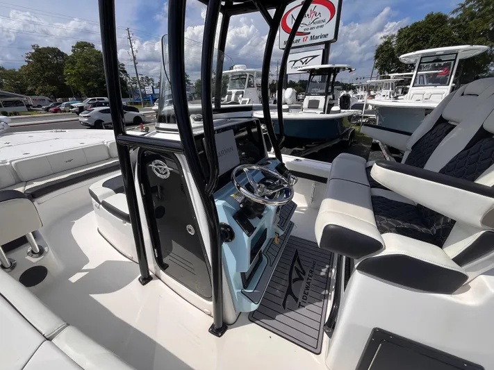  Yacht Photos Pics 2023 Tidewater 2700 Carolina Bay boat interior with steering console and seating.