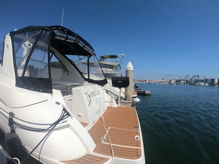 Grand Cru Yacht Photos Pics 2005 Cruisers Yachts 340 Express docked at marina under clear blue sky.