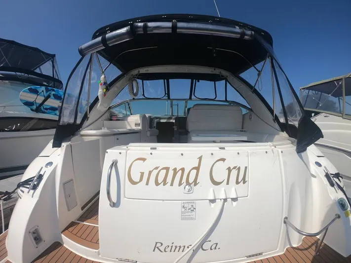 Grand Cru Yacht Photos Pics 2005 Cruisers Yachts 340 Express boat named "Grand Cru" docked under clear blue sky.