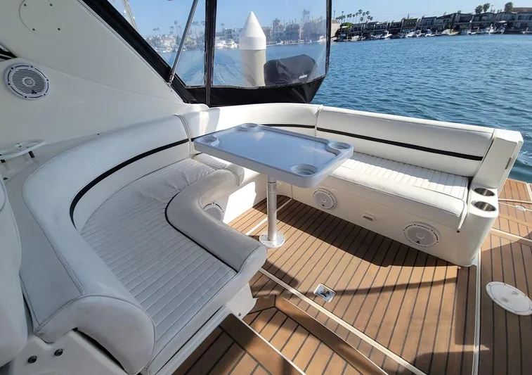 Grand Cru Yacht Photos Pics 2005 Cruisers Yachts 340 Express interior with white seating and table, overlooking marina.