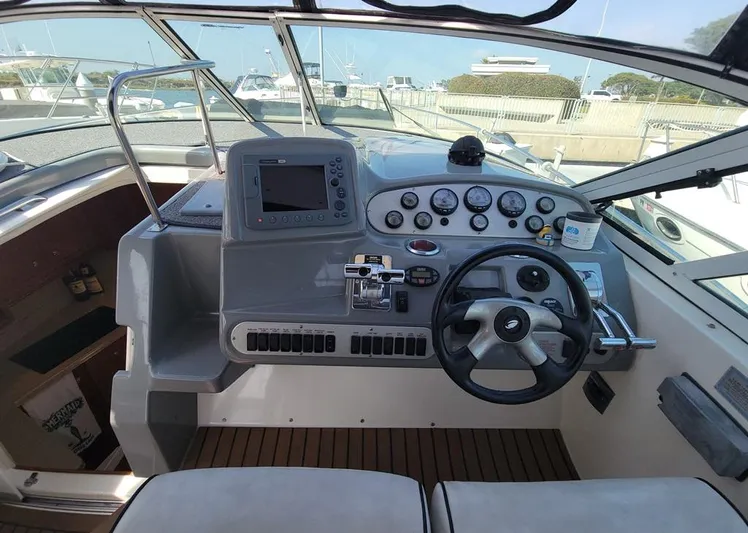 Grand Cru Yacht Photos Pics 2005 Cruisers Yachts 340 Express helm with steering wheel, gauges, and navigation controls.