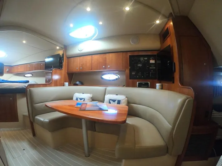 Grand Cru Yacht Photos Pics 2005 Cruisers Yachts 340 Express interior with cozy seating and wooden accents.