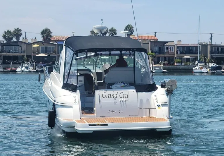 Grand Cru Yacht Photos Pics 2005 Cruisers Yachts 340 Express boat on water, rear view with canopy.