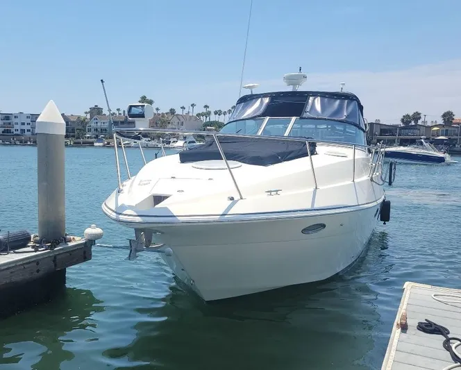 Grand Cru Yacht Photos Pics 2005 Cruisers Yachts 340 Express docked in a sunny marina.