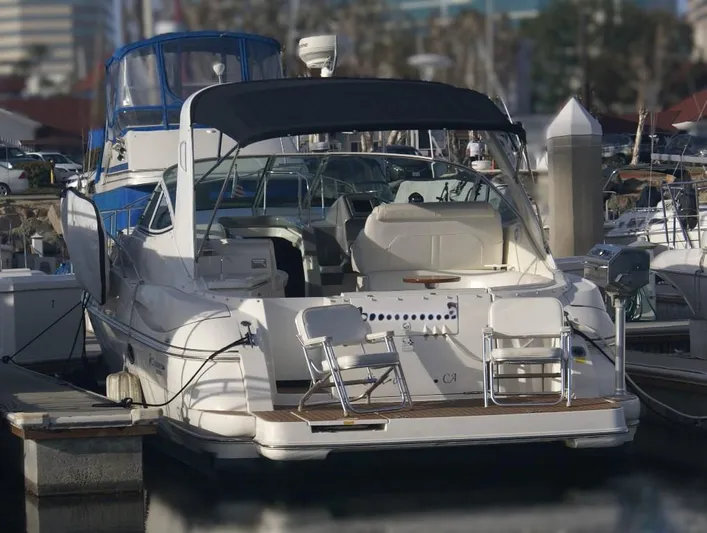 Grand Cru Yacht Photos Pics 2005 Cruisers Yachts 340 Express docked at marina, rear view with seating area.