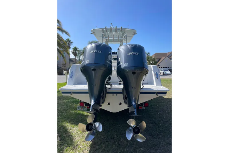 New Fuel Tanks Yacht Photos Pics 2008 Contender 27 Tournament boat with dual 300 horsepower engines, parked on grass.