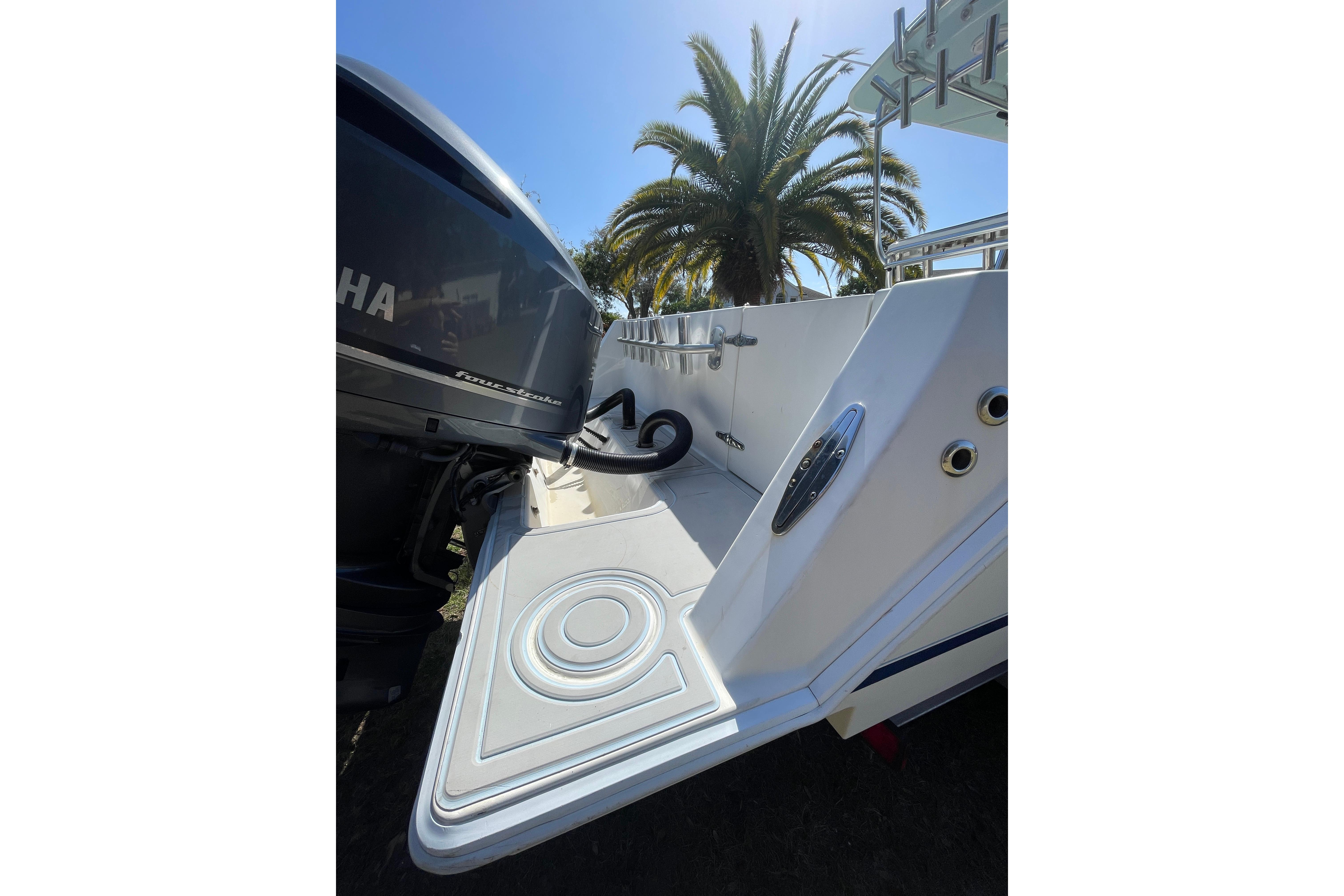 2008 Contender 27 Tournament boat with Yamaha engine, palm tree in background.