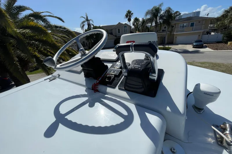 New Fuel Tanks Yacht Photos Pics Steering console of 2008 Contender 27 Tournament boat with palm trees in background.