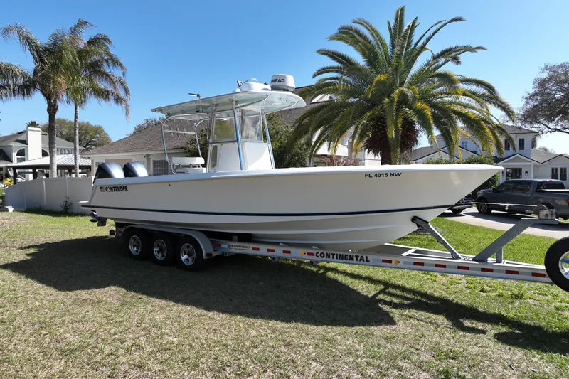 New Fuel Tanks Yacht Photos Pics 2008 Contender 27 Tournament boat on trailer, parked in a sunny residential area.