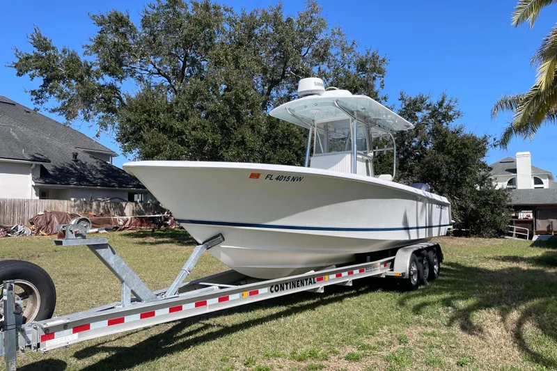New Fuel Tanks Yacht Photos Pics 2008 Contender 27 Tournament boat on trailer, parked in a grassy yard.