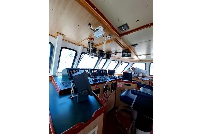  Yacht Photos Pics Bridge interior of 2008 Custom Offshore Crew Vessel with navigation equipment and seating.
