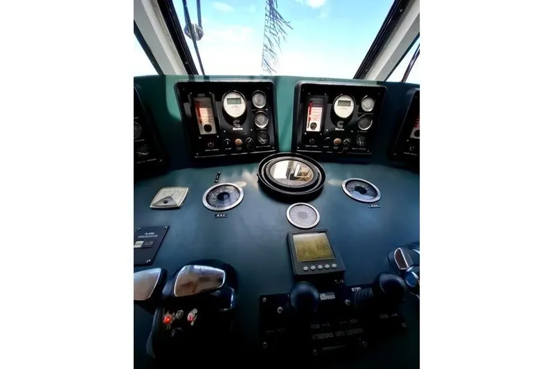  Yacht Photos Pics Control panel of a 2008 Custom Offshore Crew Vessel with gauges and navigational instruments.