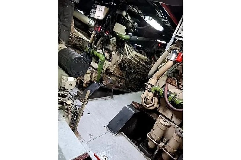  Yacht Photos Pics Engine room of a 2008 Custom Offshore Crew Vessel, showcasing complex machinery and piping.