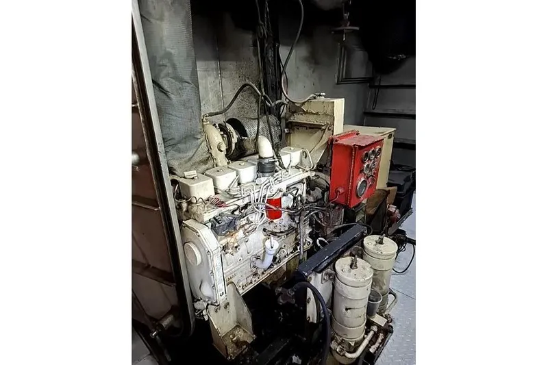  Yacht Photos Pics Engine room of a 2008 Custom Offshore Crew Vessel, showcasing machinery and control panel.