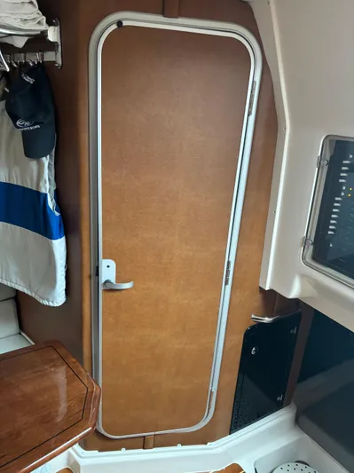  Yacht Photos Pics 2014 Grady-White Express 330 cabin interior with wooden door and nautical decor.
