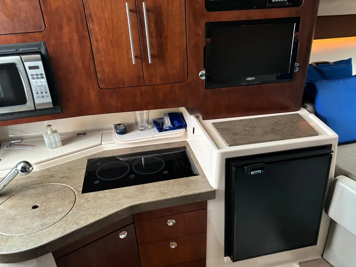  Yacht Photos Pics 2014 Grady-White Express 330 boat kitchen with microwave, stove, and fridge.