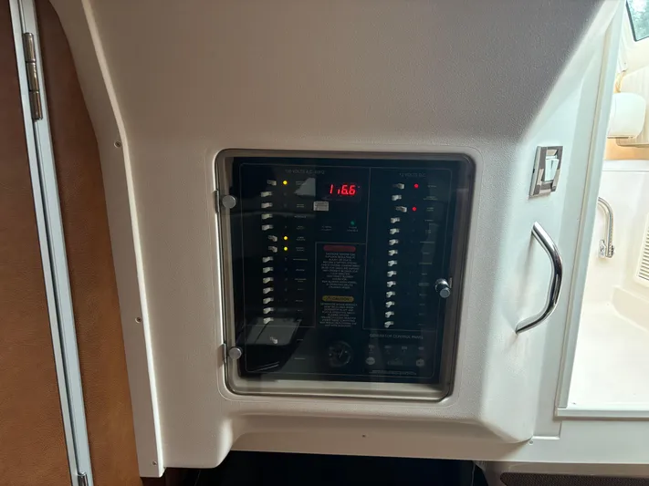  Yacht Photos Pics Electrical panel inside 2014 Grady-White Express 330 boat, featuring switches and digital display.