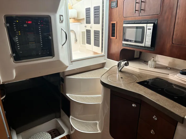  Yacht Photos Pics 2014 Grady-White Express 330 boat interior with kitchenette, microwave, and control panel.