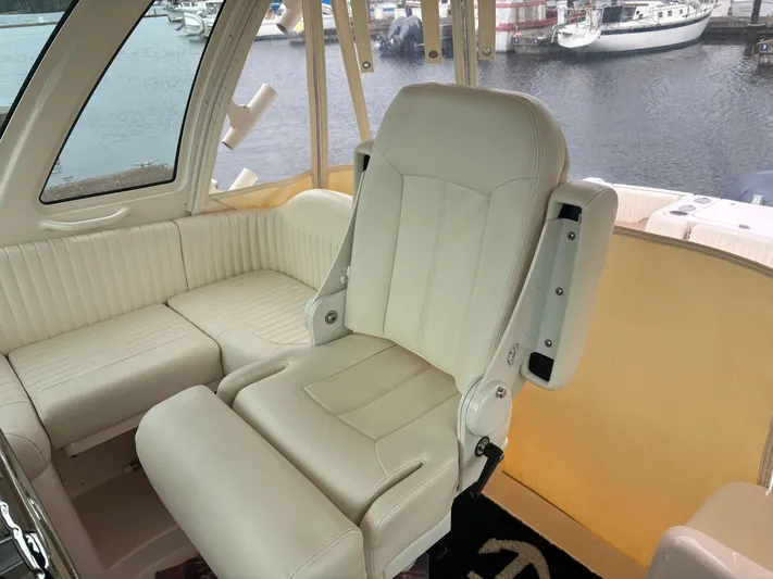  Yacht Photos Pics Luxurious seating on 2014 Grady-White Express 330 boat, featuring cream leather upholstery.